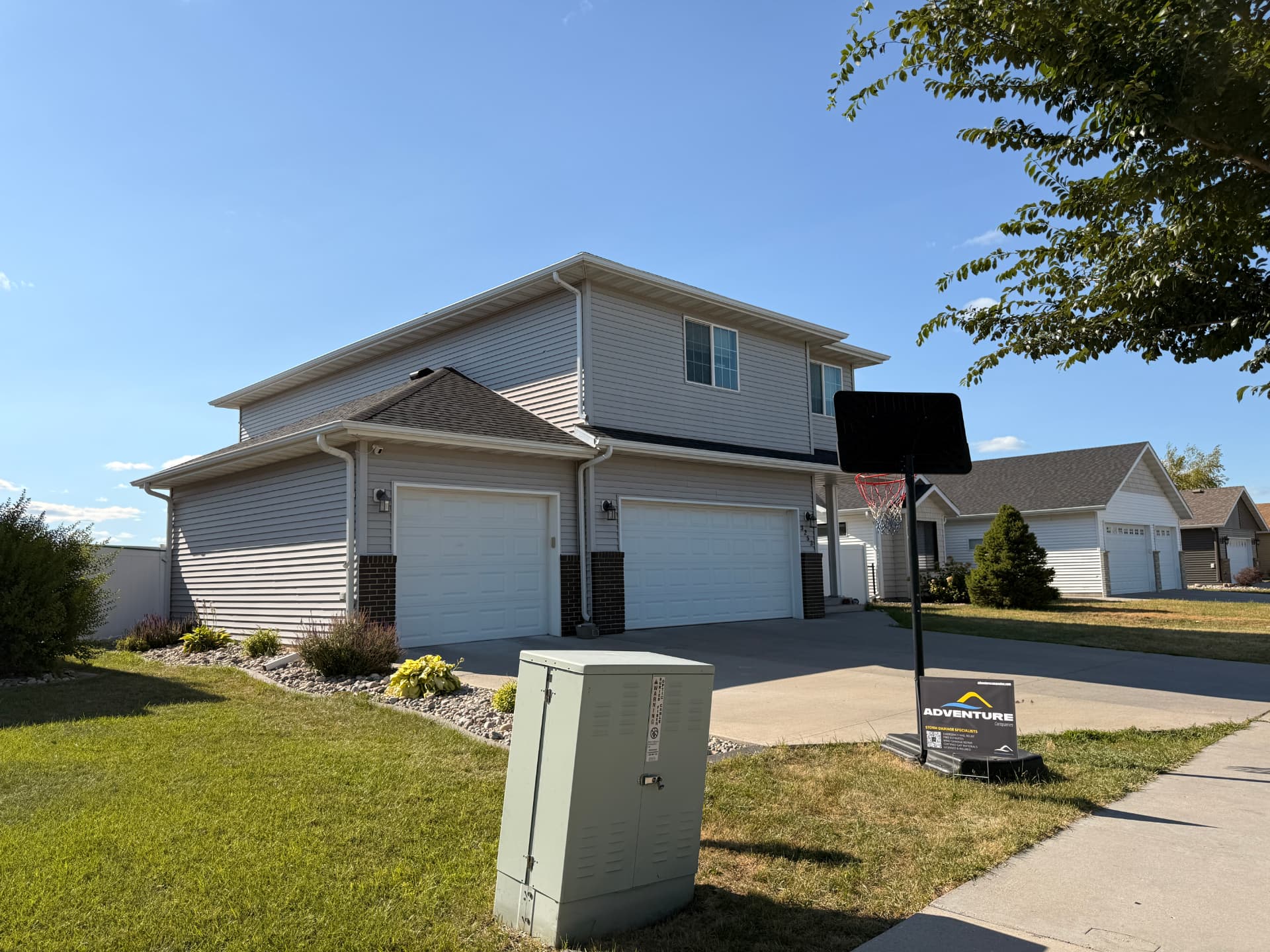 Completed storm-damage roof replacement on a two-story Moorhead, MN home with a three-car garage after the June 29, 2026 hailstorm
