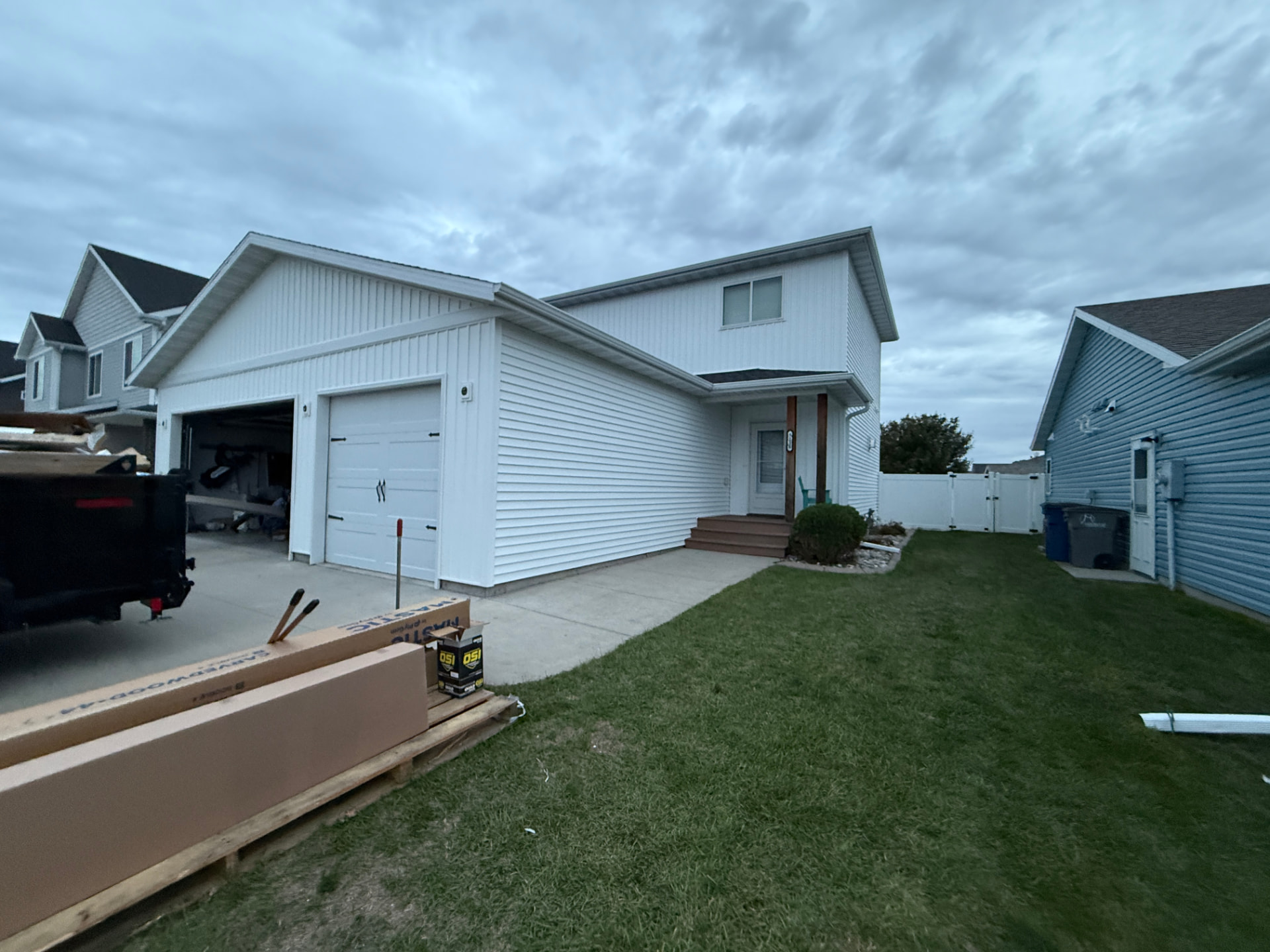 New white Mastic Carvedwood Double 4-inch dutch lap vinyl siding along the garage and entry of a Moorhead home
