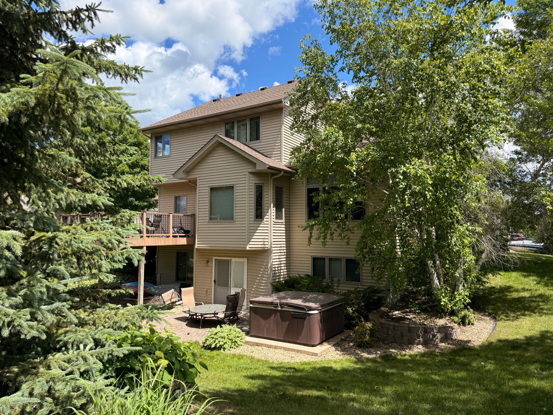Rear view of the completed roof, gutter, and custom fascia replacement on a Rogers, MN home after a hailstorm