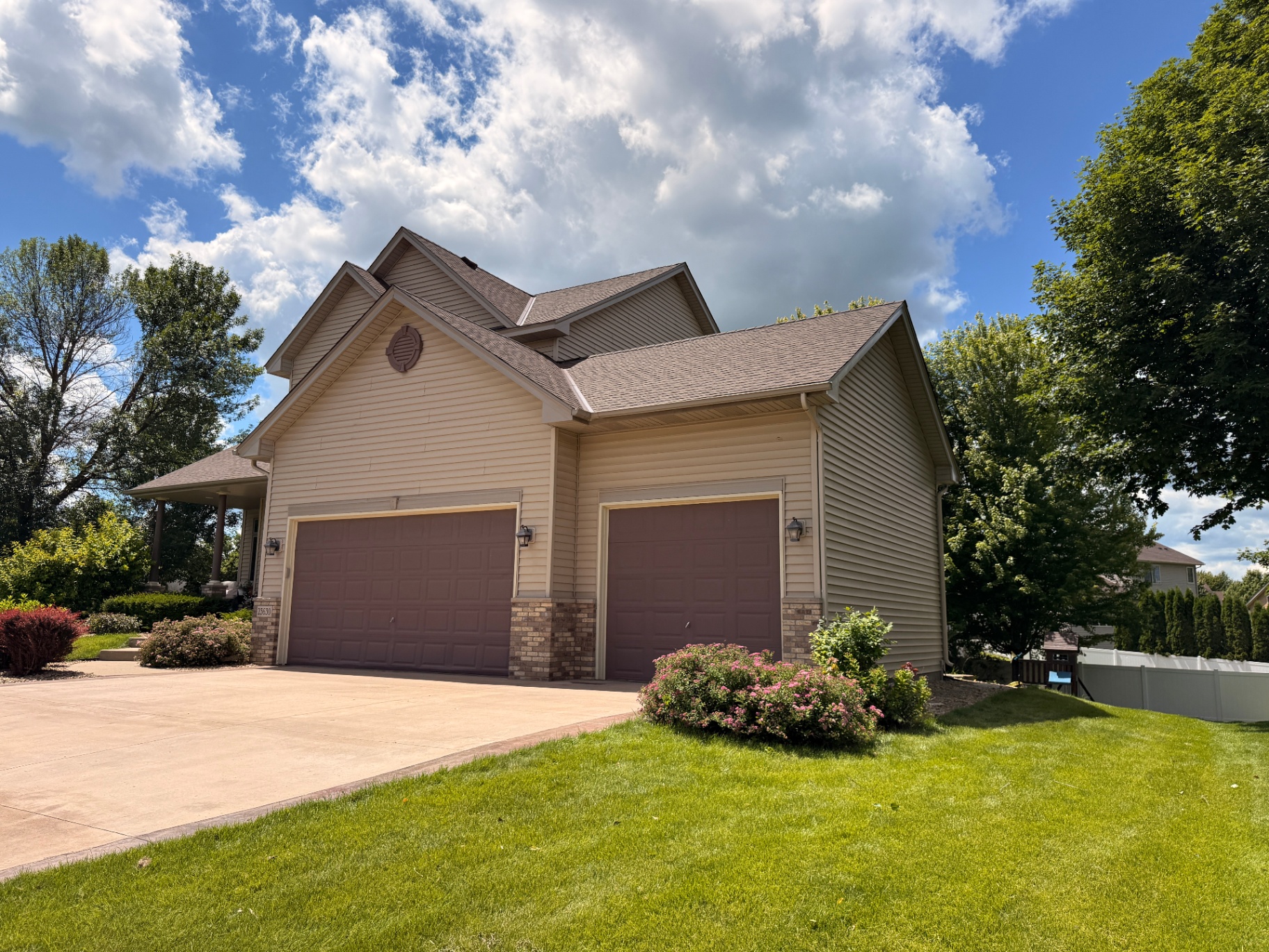 New roof, gutters, downspouts, and custom fascia on the garage gable of a Rogers, Minnesota home after hail damage