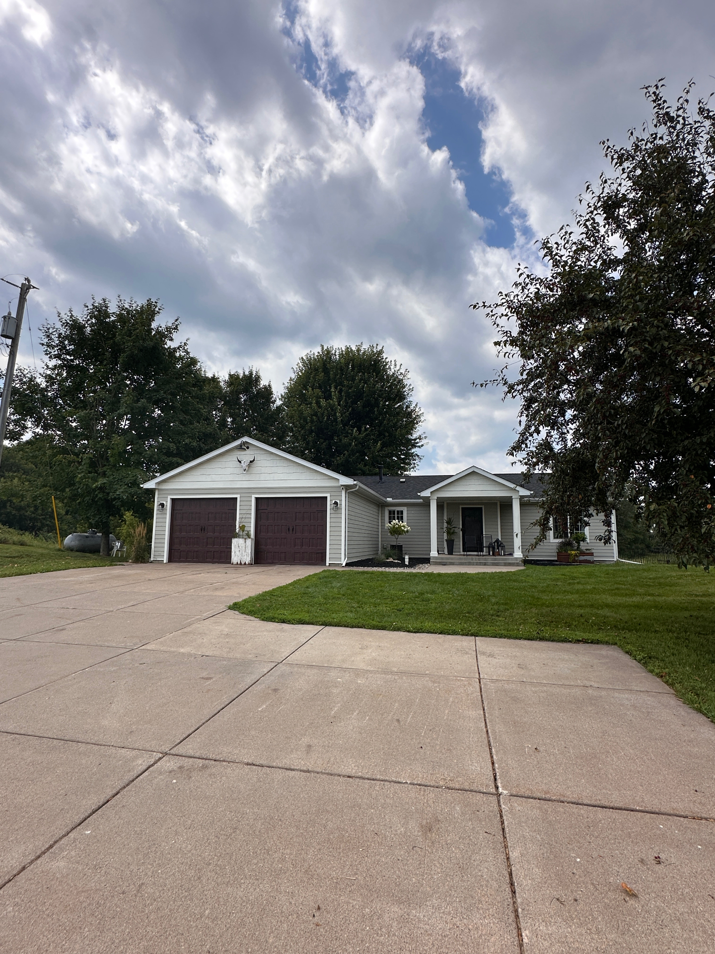 Completed roof replacement — front elevation of a Lindstrom, MN home with new architectural shingles