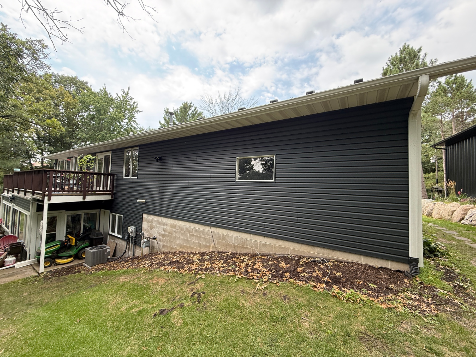 Rear of the Elk River, MN home showing the new Royal Brunswick siding and GAF Timberline HDZ Charcoal roof