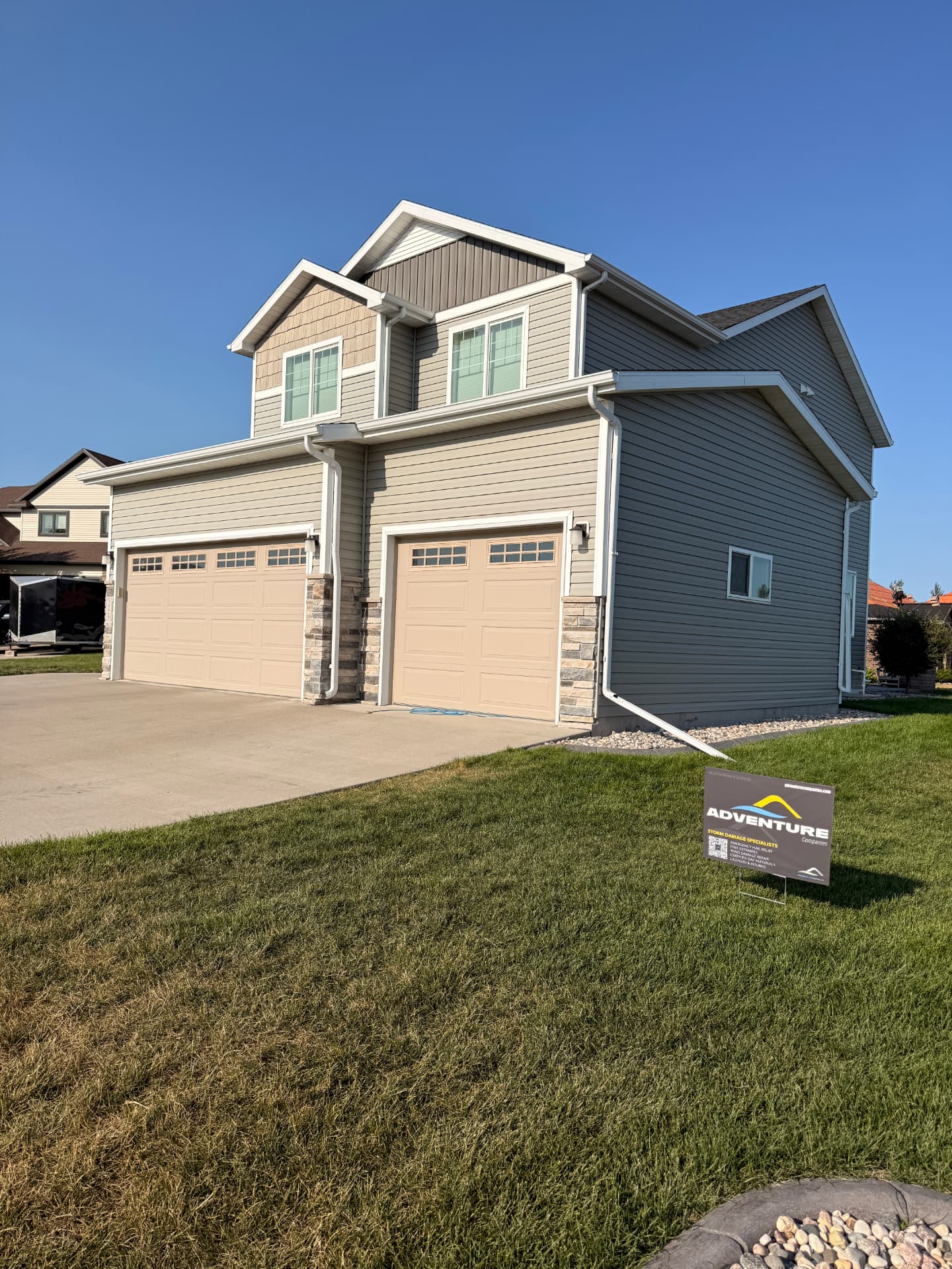 Two-story Moorhead, MN home with a newly replaced roof after the June 29, 2026 storm, siding replacement pending